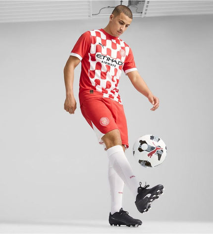 Puma Girona home football jersey replica with team logo and sponsor details, designed for fans and sports enthusiasts.