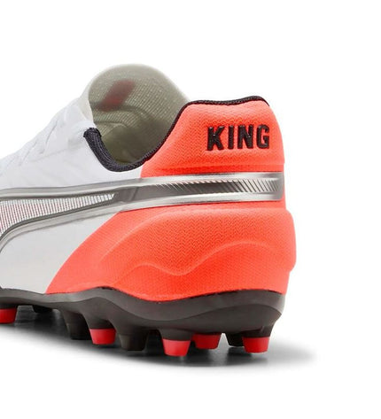 Adult Puma King Match MG football cleats for outdoor soccer, featuring black and white design with studded rubber sole.