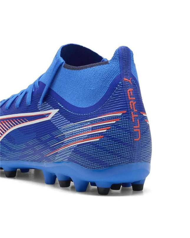 Puma Ultra 6 Match+ MG adult soccer cleats showing black and red design, lightweight sport footwear for outdoor football.