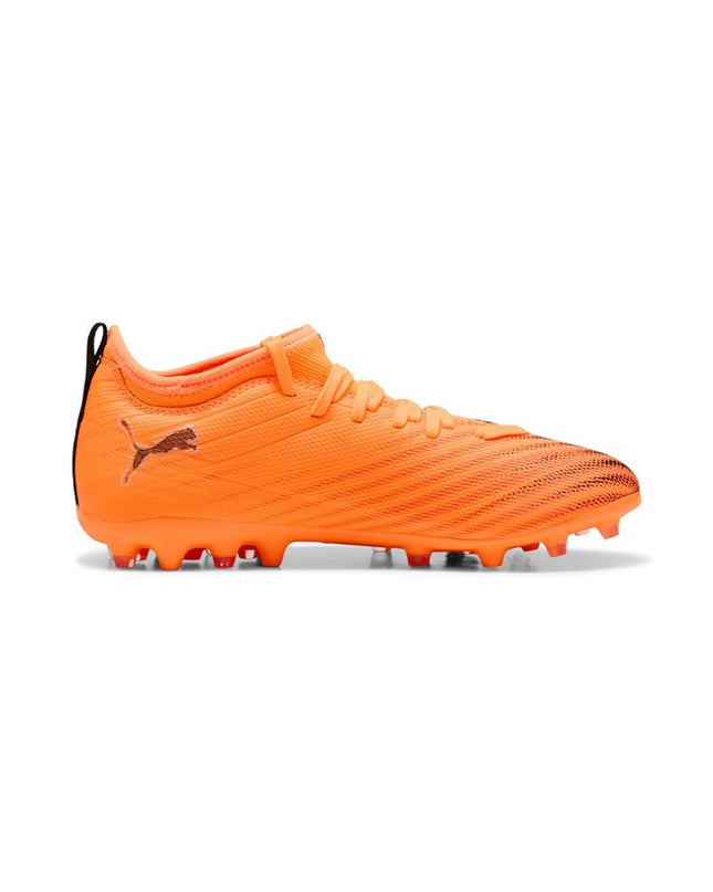 Puma Ultra 6 Match Mg Heat Fire football cleats for sport and outdoor soccer, black with orange accents, in action.