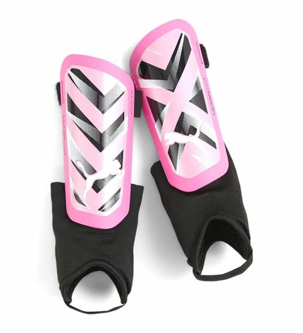 Dark pink Puma Ultra Light soccer shin guards showing lightweight design and padded protective areas for sports and outdoor use.