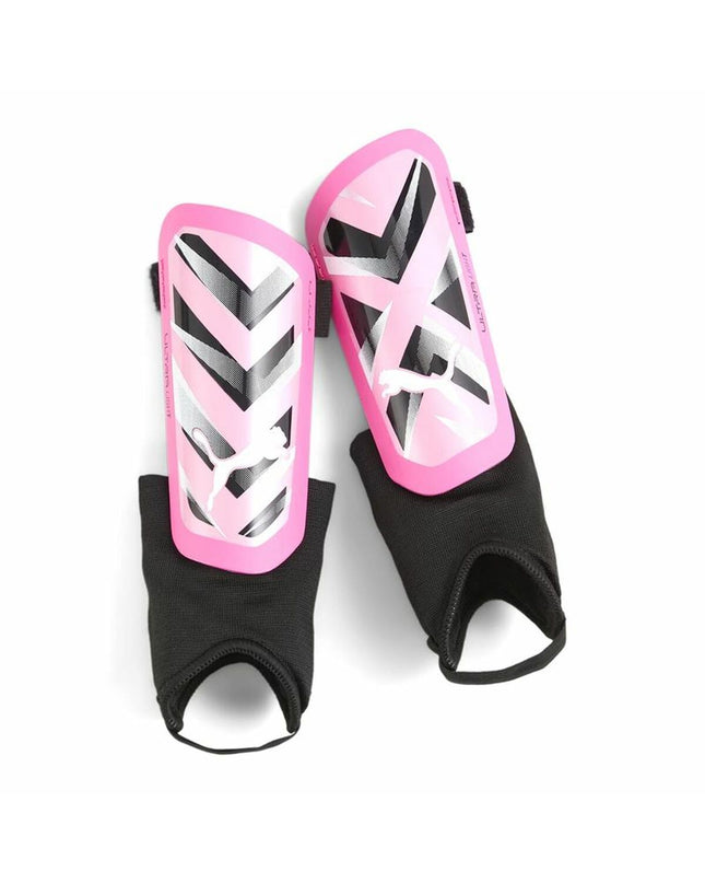 Dark pink Puma Ultra Light soccer shin guards showing lightweight design and padded protective areas for sports and outdoor use.