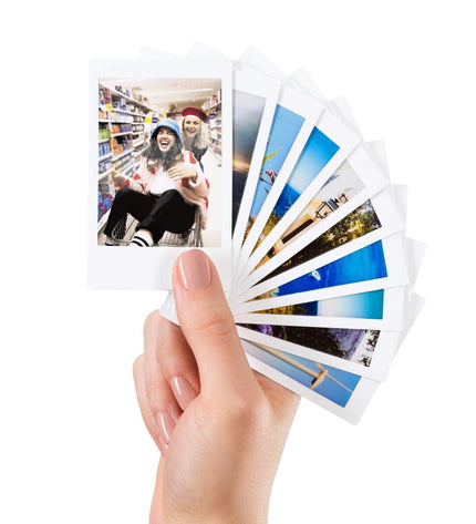 Fujifilm Instax Mini 10 digital camera with glossy finish, compact electronic device for instant photography, shown with film copies