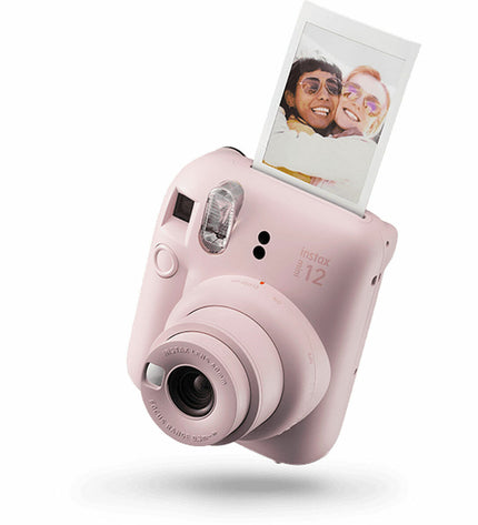 Fujifilm Mini 12 instant photo camera in pink, compact electronic device for photography and instant print photos.