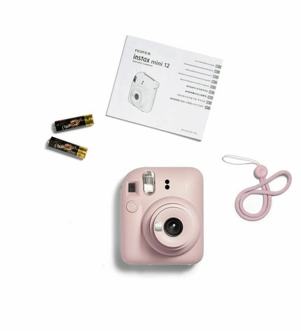 Pink Fujifilm Mini 12 instant camera with compact design, perfect for fun photography and instant photo printing.