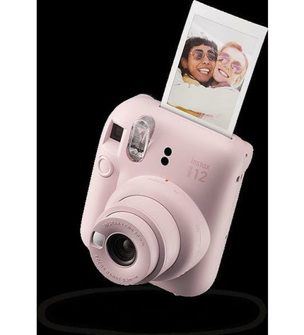 Fujifilm Mini 12 instant photo camera in pink, compact electronic device for photography and instant picture printing.