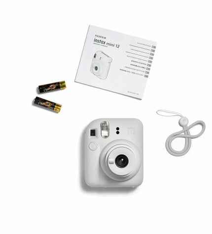 Fujifilm Mini 12 instant camera in white, compact electronic photography device with lens and viewfinder visible
