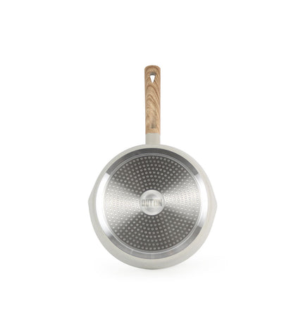 Set of six Quttin kitchen pans for home cooking, featuring durable cookware with handles, arranged on a white surface.