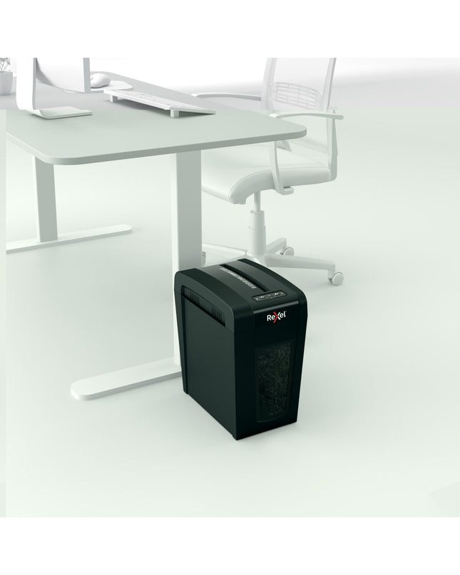 Rexel Secure X10-SL paper shredder for office use, with metal construction and control panel, on a clean office desk.