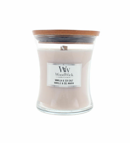 Woodwick scented candle in a glass container, featuring a wooden wick for a cozy home decor ambiance.
