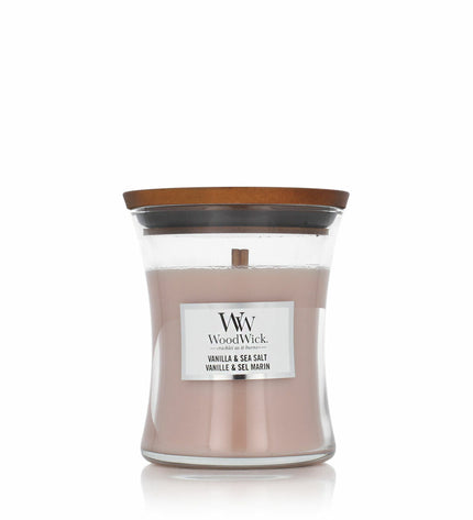 Woodwick Woodwick scented candle with wooden wick, cream-colored glass jar, and decorative lid for home decor and ambiance.