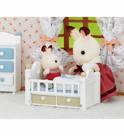 Sylvanian Families Baby Rabbit Chocolate Bed action figure toy, detailed miniature bunny with chocolate-themed bed accessory