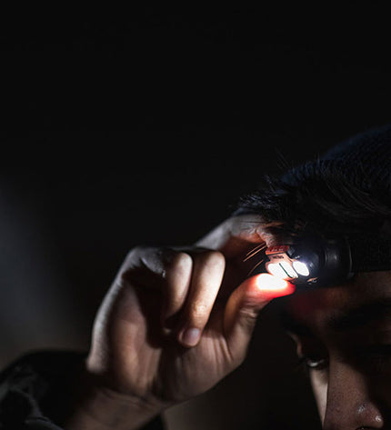Nebo Einstein™ 1000 Flex LED headlamp for outdoor camping and hiking, with adjustable strap and bright light in black.