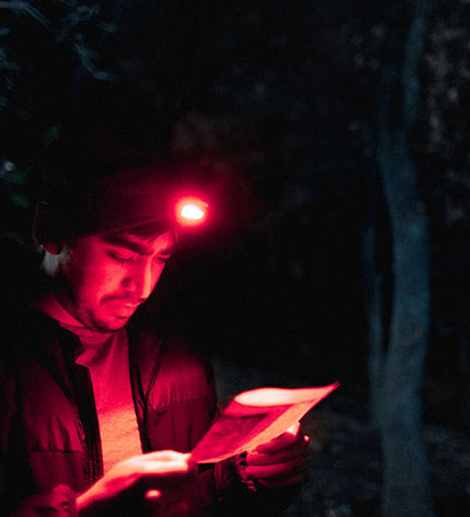 Nebo Einstein™ 1000 LED headlamp for outdoor activities, showing adjustable straps and bright light beam, ideal for camping and hiking.