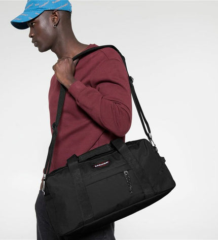 Black Eastpak sport and outdoor bag with sturdy design, featuring a spacious main compartment and adjustable straps.