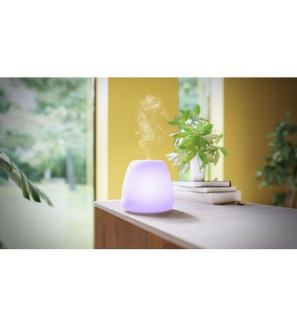 Ultrasonic glass essential oil diffuser by Pranarôm with LED lights, designed for home decor and aromatherapy.