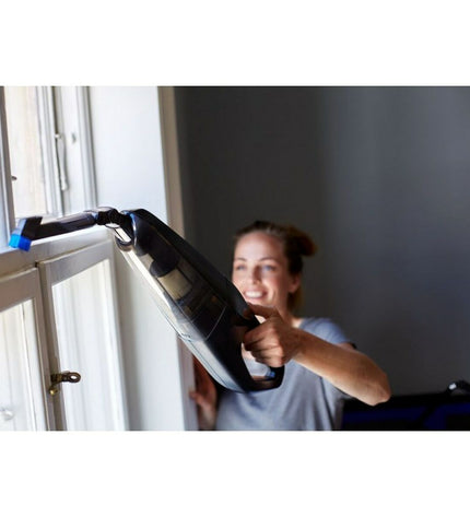 Nilfisk EASY steel vacuum cleaner for home cleaning, showing the compact design and adjustable hose in a home environment.