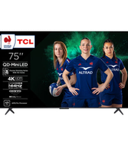 TCL 75C6K 75-inch 4K Ultra HD HDR QLED Mini LED smart TV displaying vibrant colorful images in a modern living room setting.