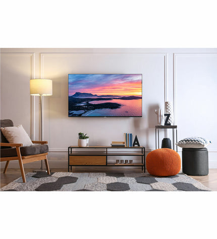 TCL 40S5K 40-inch Full HD LED HDR QLED Smart TV displaying vibrant colorful screen in a modern living room setting