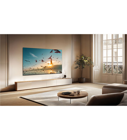 TCL 75-inch 4K Ultra HD HDR QLED smart TV displaying vibrant colorful images in a modern living room setting