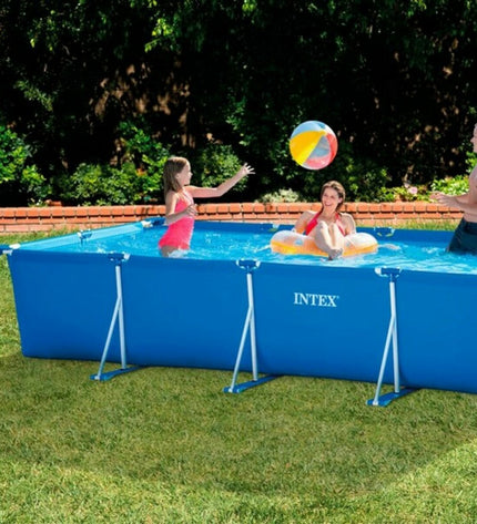 Intex removable pool with 450x84x220 cm size, set up outdoors in a garden, featuring blue inflatable sides and water.