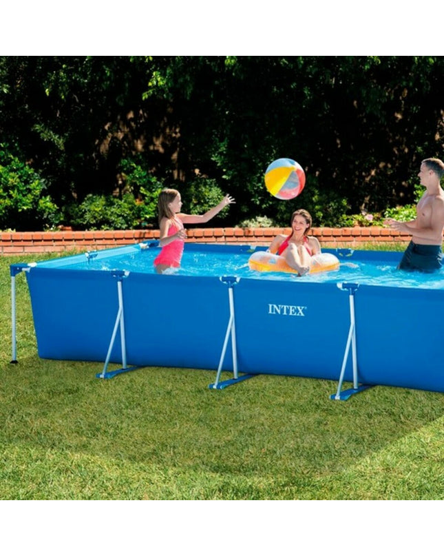 Intex removable pool with 450x84x220 cm size, set up outdoors in a garden, featuring blue inflatable sides and water.