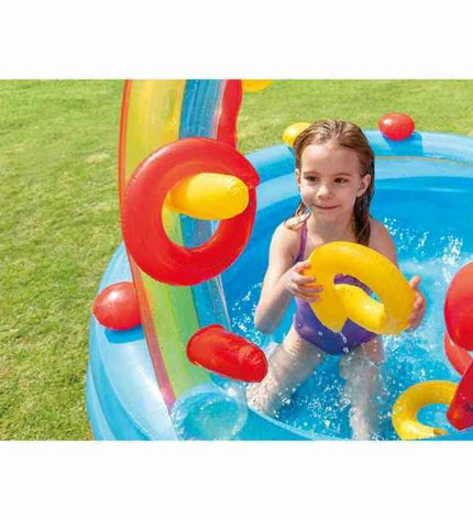 Intex inflatable kids' rainbow play pool with colorful design, measuring 297x135x193 cm, filled with water for outdoor fun