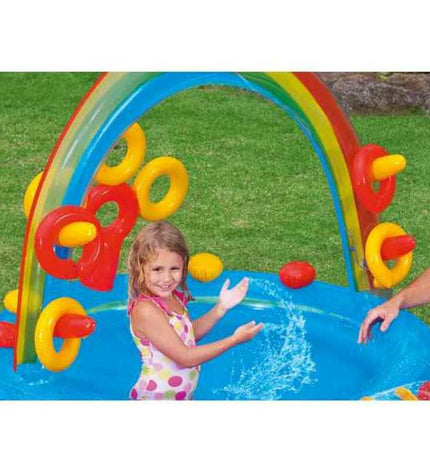 Intex inflatable children's rainbow pool with slide and play area, measuring 297 x 135 x 193 cm, filled with water.