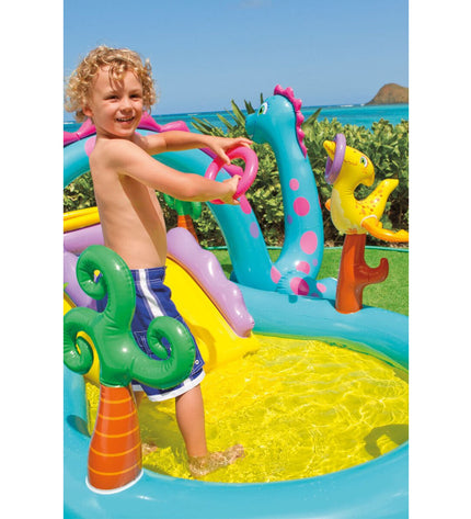 Intex inflatable kids' pool with dinosaur playground, measuring 302 x 112 x 229 cm, filled with water and featuring colorful dinosaur figures.