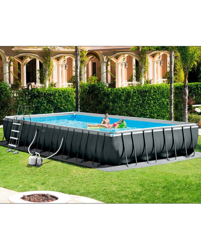 Intex 26378 removable backyard swimming pool, 975 x 132 x 488 cm, with water filled and set up outdoors in a garden setting.