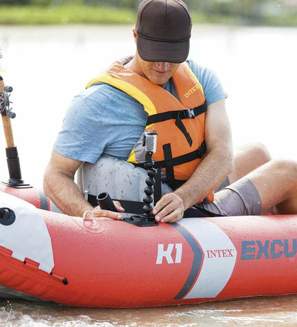 Inflatable kayak Intex Excursion Pro in blue with black accents, featuring seating area and paddles, suitable for outdoor watersport adventures.