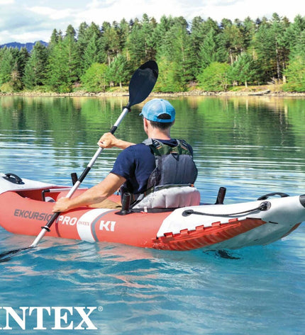 Inflatable kayak Intex Excursion Pro in blue with black accents, shown on water with paddles and safety features.