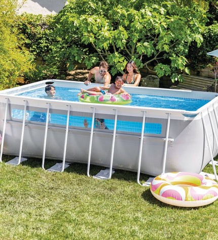 Intex removable swimming pool in garden, rectangular shape, 400x122x200 cm, with water and pool lining visible.