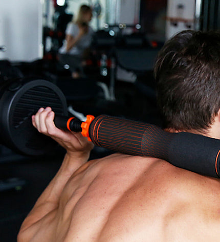 Xiaomi ORMANBAS35 35 kg black and multicolour dumbbells for fitness and outdoor exercise, shown in a gym setting.