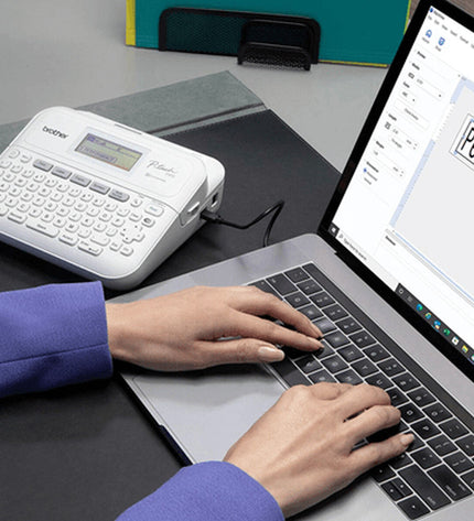 Brother PTD410UR1 label printer for office use, showing the compact device with buttons and label output on a clean background.