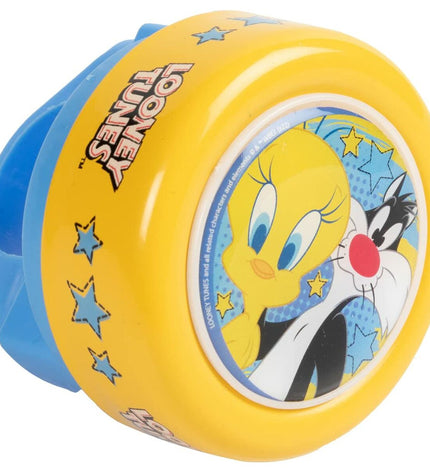 Yellow Looney Tunes bicycle bell for kids' bike, featuring Looney Tunes character design, mounted on a children's bicycle.