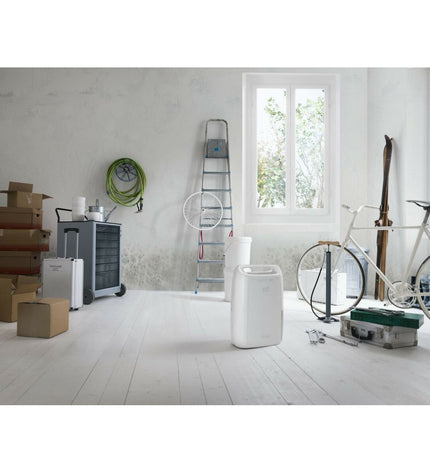 DeLonghi DEX210SF white portable air conditioner for home and kitchen, with vents and control panel visible.