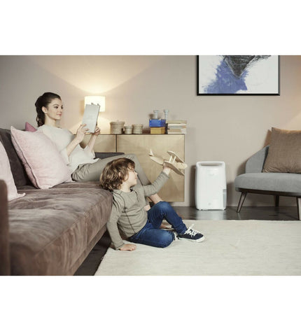 DeLonghi DEX210SF white portable air conditioner with air purifier function, designed for home cooling and air cleaning.