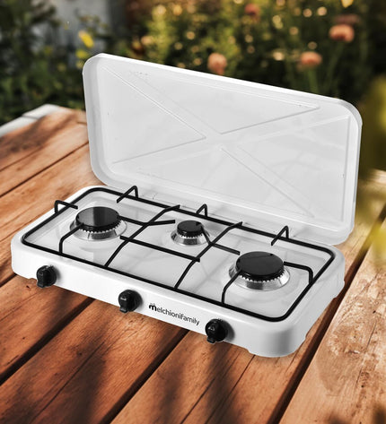 Melchioni MINERVA3 gas stove for camping and outdoor cooking, compact design with control knobs and sturdy metal construction.
