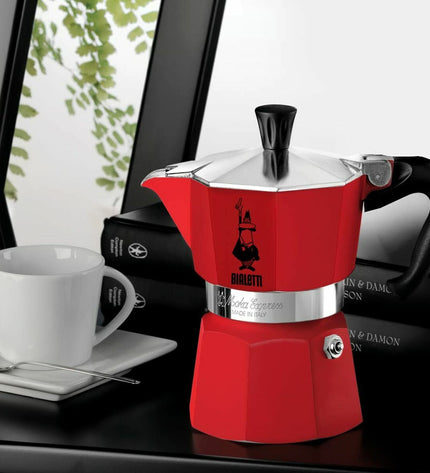Red Bialetti Italian coffee pot with 6 cups, stovetop moka maker for rich espresso-style coffee, ideal for home brewing.