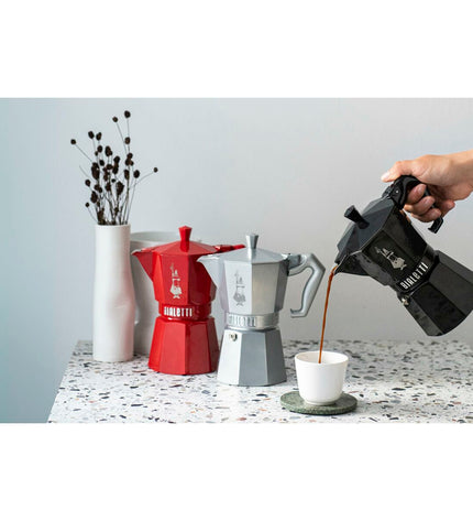 Red Bialetti Moka Express Italian coffee pot in aluminium for 3 cups, designed for home brewing of rich espresso-style coffee.