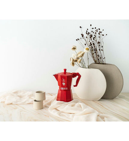 Red Bialetti Moka Express Italian coffee pot in aluminum, 6-cup size for brewing authentic espresso at home.