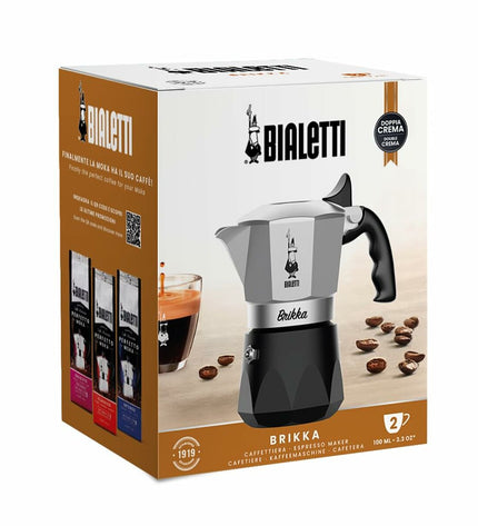 Bialetti Brikka Italian coffee pot in black aluminum with two cups, ideal for making rich espresso-style coffee at home.