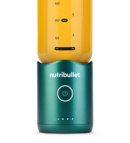 Nutribullet NBP013GR green mixer in kitchen setting, compact electric kitchen appliance for blending and food preparation.