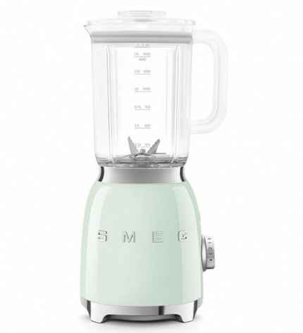 Smeg BLF03PGEU 800W compact kitchen mixer with 1.5L capacity, white and pink design, on a kitchen countertop
