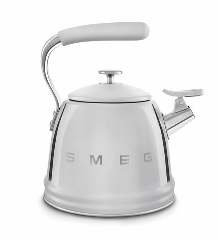Smeg WKF01SS gray 2.3L teapot in kitchen setting, showcasing sleek design and stainless steel finish for brewing tea or hot beverages.