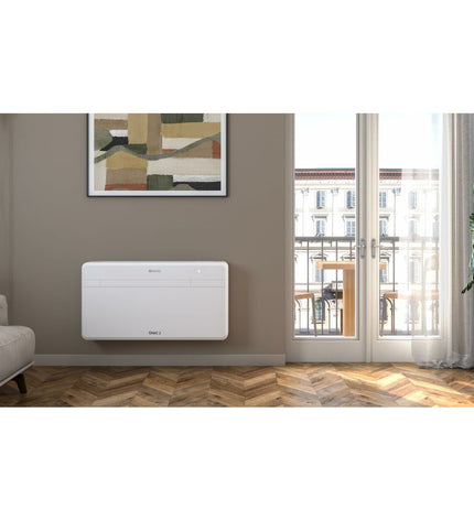 Portable Olimpia Splendid Wit air conditioner shown with vents and control panel in a home setting.