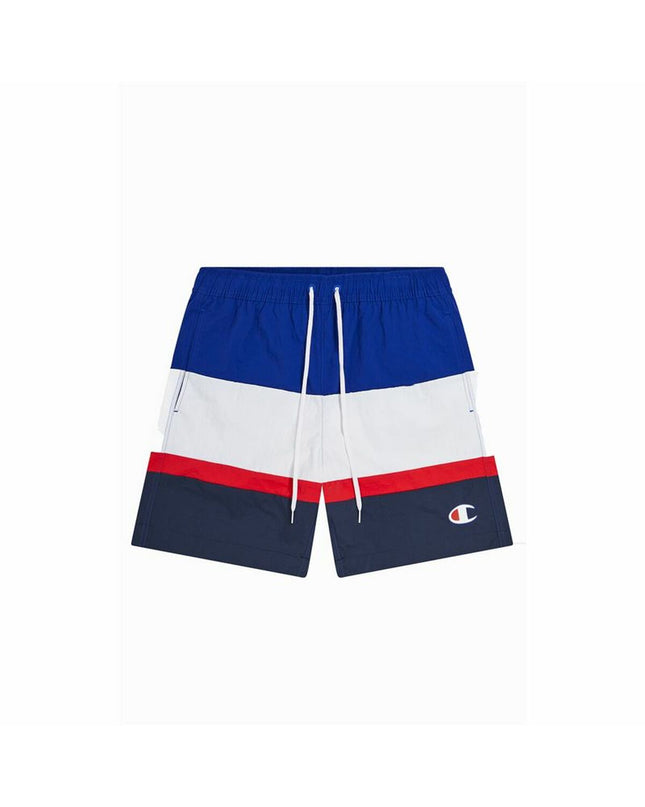 Champion men's blue swim trunks for sports and outdoor watersports, shown on a model at the beach.