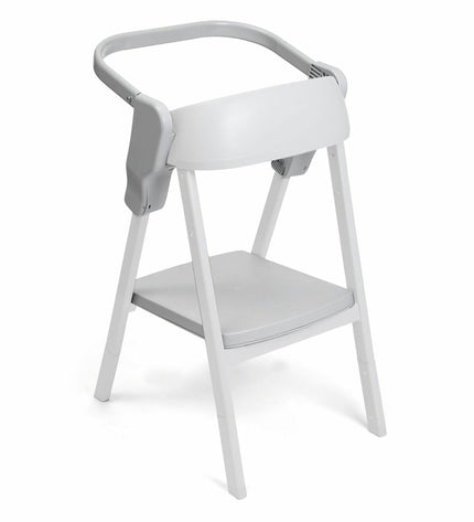Child's Chicco baby chair with a soft cushion and wooden legs, suitable for a cozy nursery or bedroom setting.
