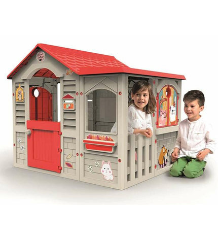 Chicos Grand Cottage XL children's playhouse in bright colors with windows and door, designed for outdoor play and fun.